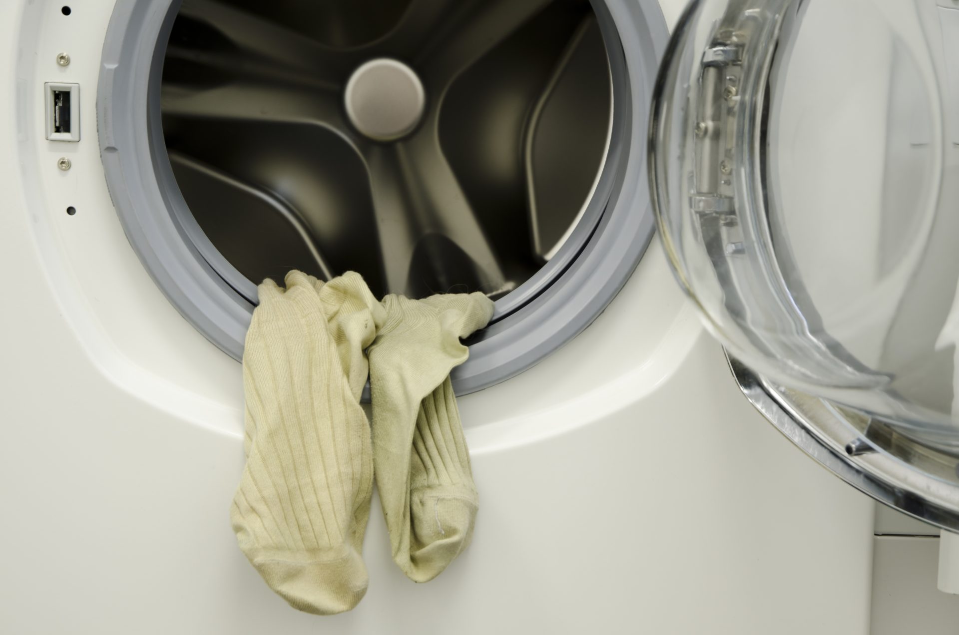 closeup-shot-of-the-dirty-laundry-hanging-from-the-washing-machine-1